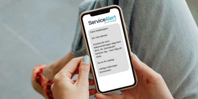 Person håller smartphone med ServiceAlert-SMS på svenska som påminner medborgare att rösta före kl. 20 och lyfter demokratins betydelse.